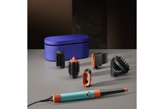Image Dyson air wrap with its tools spread out on the ground.