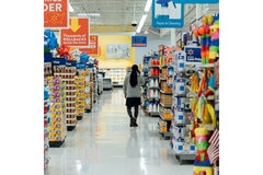Image Man walking down supermarket aisle