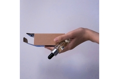Holding perfume and packaging in hand.