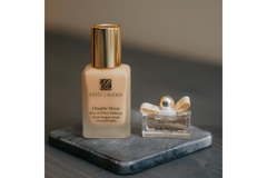 Image Estee Lauder double wear foundation on a coaster.