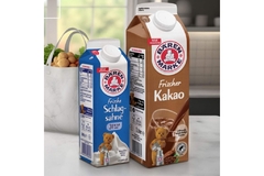 Image A group of cartons of milk and a bag of vegetables.