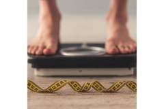 Image Person standing on a weight scale.