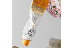 Image A tube of hair dye that is partially crushed.