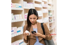 Woman checking safety status of ashwagandha supplements on her phone.
