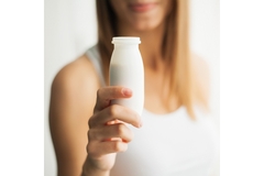 Image Woman displays a probiotic beverage
