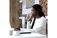 Image Woman drinking water while typing