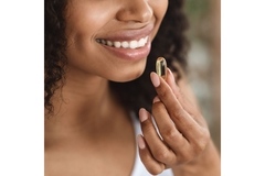 Image Woman takes beauty supplement keratin