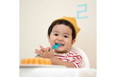 Image Baby boy smiles with of a cake