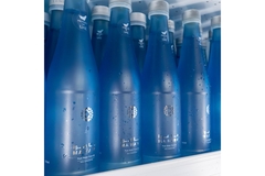 Image A group of blue water bottles on a shelf.