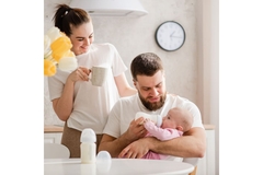 Image Father and mother feed infant formula