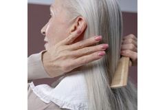 Image woman with white long hair combing