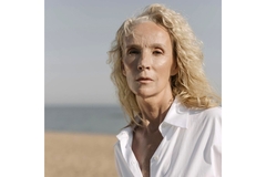 An older woman staring into the camera.
