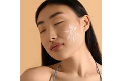 Image clear skinned woman with sun screen on face