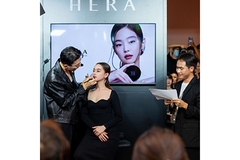 Image A woman getting her makeup done on a stage.