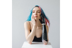 Woman with prosthetic arm with dyed hair