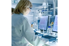 Scientist working on a computer in a lab.