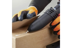 A person holding a tool for hot melt adhesives.