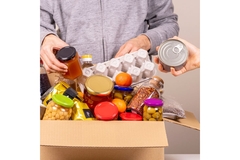 Image Person packing a box with food donations.