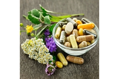 Supplements with plants next to them in a bowl.