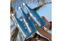 A group of people holding up Ma Hawa bottles