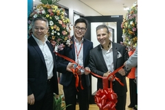 Image three people around cutting ribbon