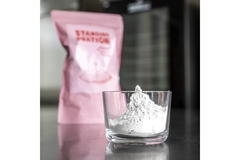 Image a white powder in a glass container.