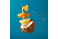 floating coconut split in half with slices of orange floating above it