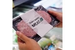 Image Holding meat in plant-based packaging.