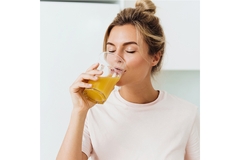 Woman drinking orange juice.