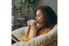 Woman enjoying a cup of stress ease tea.