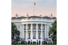 The White House with dark clouds forming behind it.