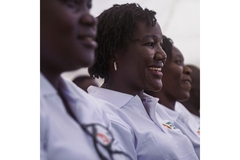 Image Kenyan women standing in line for graduation.