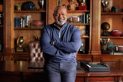 Emmitt Smith standing in front of a desk in a study.