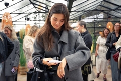 A girl using a skin moisturization tool on her hand.