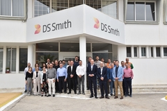 A group of people standing in front of a DS Smith building