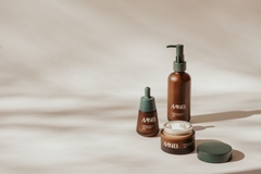 Products from MN8 in front of a beige background.