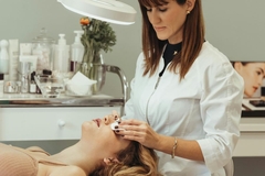 Image An esthetician treating her patient.