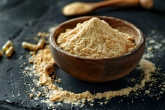 Image yeast extract powder in a wooden bowl.