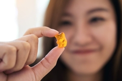 Woman hold gummy supplement