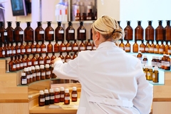 Image A chemist browsing fragrance bottles.