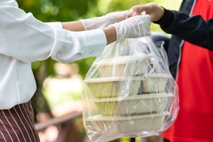 Image Handing over takeaway packaging.