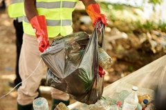 Image Collecting packaging waste using plastic bag.