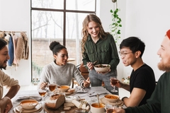 Image A group of friends happily eating together.