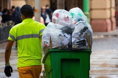 Pushing waste cart.