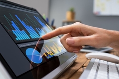 Image A finger pointing at a screen, showing diagrams.