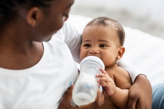 An infant being bottle fed.