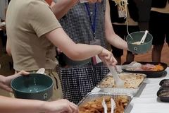 Image A group of people serving food with ReCube bowls.