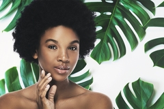 Image Woman applying organic sunscreen.
