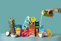 Image various plant-based drinks against a green background.