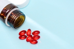 Image Bottle with red capsules.